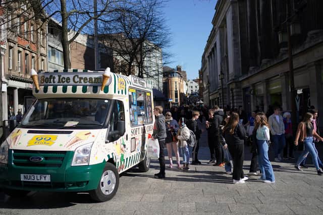 Shoppers in Nottingham city centre queue for an ice cream during good weather.