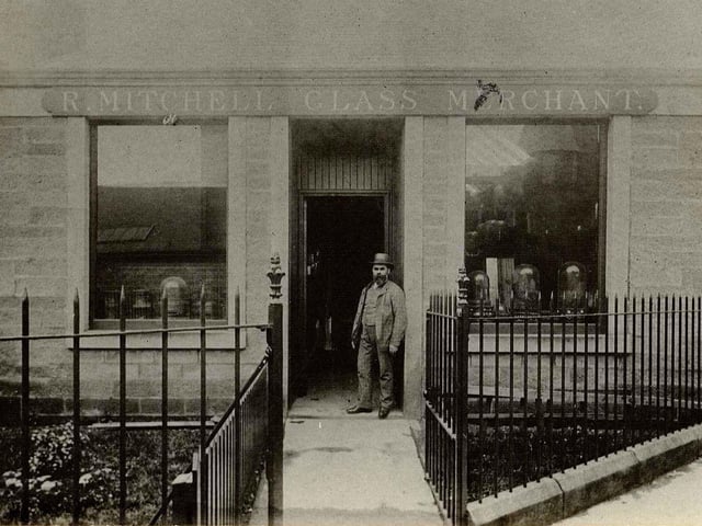 Robert Mitchell outside his first store in 1875