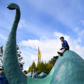 Children play on a Loch Ness monster sculpture at Nessieland in Drumnadrochit in the Highlandsn(Picture: Andy Buchanan/AFP via Getty Images)