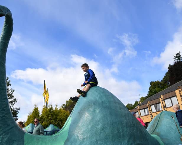 Children play on a Loch Ness monster sculpture at Nessieland in Drumnadrochit in the Highlandsn(Picture: Andy Buchanan/AFP via Getty Images)