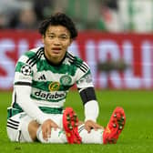 Celtic's Reo Hatate goes down injured during the Champions League match against Atletico Madrid. (Photo by Craig Williamson / SNS Group)
