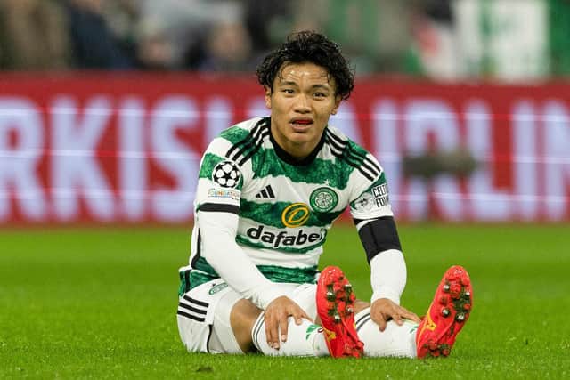 Celtic's Reo Hatate goes down injured during the Champions League match against Atletico Madrid. (Photo by Craig Williamson / SNS Group)