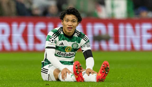 Celtic's Reo Hatate goes down injured during the Champions League match against Atletico Madrid. (Photo by Craig Williamson / SNS Group)