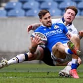 Stand off for the day Stuart Hogg is in the thick of the midfield action with this tackle on Italy's Mattia Bellini