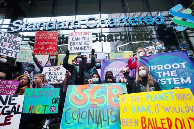 Young activists take part in the Youth Strike to Defund Climate Chaos protest against the funding of fossil fuels outside Standard Chartered Bank in London ahead of the COP26 summit in Glasgow.