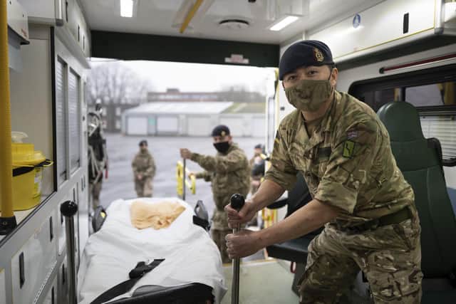 Members of the military practice loading and unloading a stretcher into an ambulance. Picture: Matthew Horwood/Getty Images