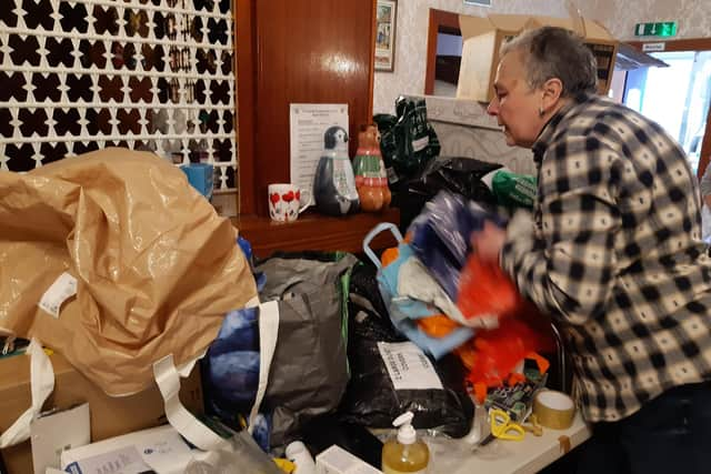 Irina Shlumukova, who is from eastern Ukraine, works to help sort donations.