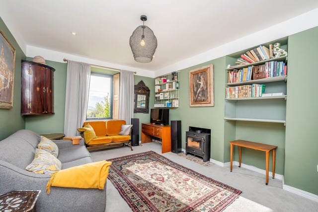 Interior: A welcoming entrance hall with dining area leads to a lounge and sleek open-plan kitchen and family area, with glazed sliding doors providing plenty of light. Three bedrooms are set across two floors.