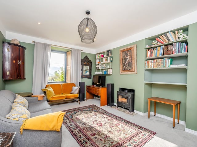 Interior: A welcoming entrance hall with dining area leads to a lounge and sleek open-plan kitchen and family area, with glazed sliding doors providing plenty of light. Three bedrooms are set across two floors.