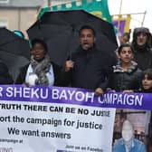 The sister of Sheku Bayoh, Kadi Johnston (centre) and Human rights lawyer Aamer Anwar (right) during a anti-racism and anti-fascist march in Glasgow,