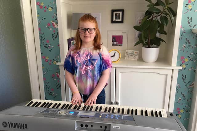 Nuala McConville playing her borrowed Yamaha keyboard for her family. Picture: Contributed