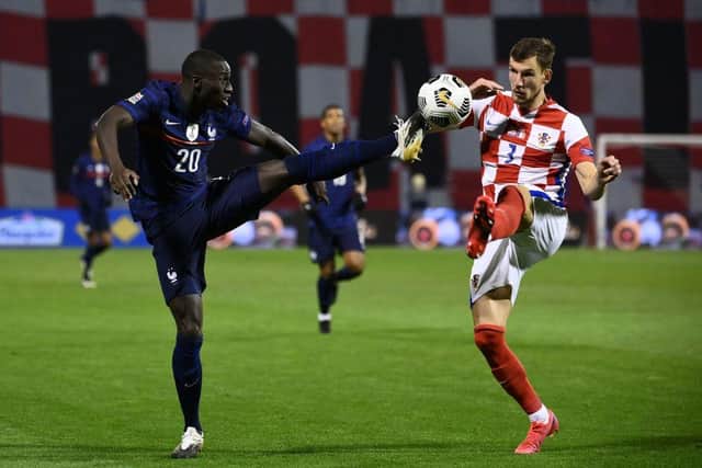 France's defender Ferland Mendy vies for the ball with Croatia's defender Borna Barisic during the UEFA Nations League Group match between Croatia and France. (Photo by FRANCK FIFE/AFP via Getty Images)