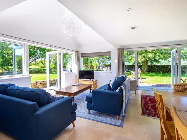 Interior: The reception hall leads to a cosy snug and a rear open-plan kitchen, dining and family room. Upstairs are three bedrooms and the principal has an ensuite.