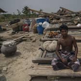 Fisherman Md. Mizan Molla from Bangladesh sits in front the wreckage of the house he shares with his parents, wife and brothers after a storm struck