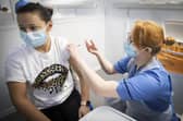 Nurse Eleanor Pinkerton administers a coronavirus vaccine to one of the health and social care staff at the NHS Louisa Jordan Hospital in Glasgow on January 23.