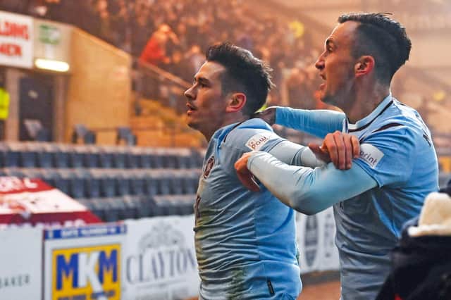 Hearts' Jamie Walker celebrates his winning goal against Dundee in front of the travelling fans.