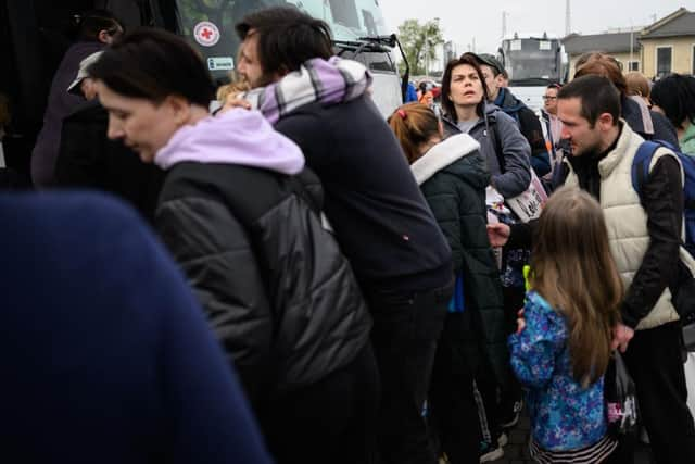 Refugees from the war torn regions of Ukraine board a coach to Poland at a coach station.