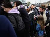 Refugees from the war torn regions of Ukraine board a coach to Poland at a coach station.