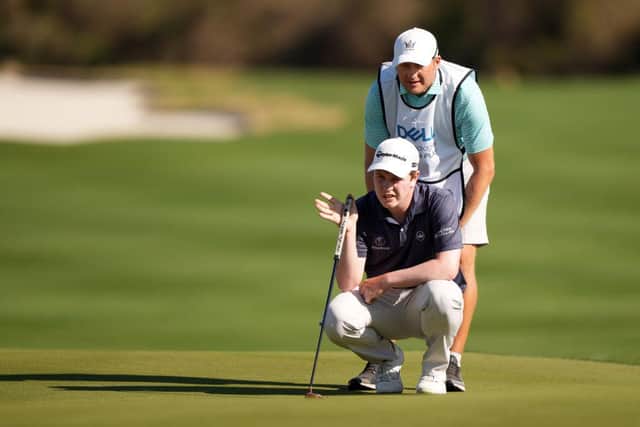 Bob MacIntyre lines up a putt with his caddie Mikey Thomson at Austin Country Club in Texas. Picture: Darren Carroll/Getty Images.