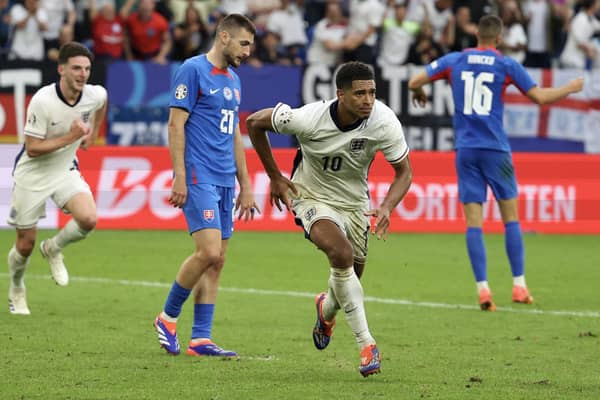 Jude Bellingham celebrates scoring England's injury-time equaliser against Slovakia at Euro 2024. (Photo by ADRIAN DENNIS/AFP via Getty Images)