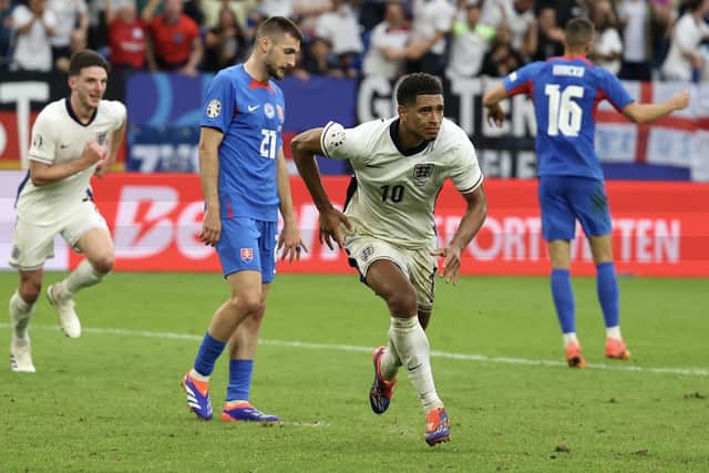 Jude Bellingham celebrates scoring England's injury-time equaliser against Slovakia at Euro 2024. (Photo by ADRIAN DENNIS/AFP via Getty Images)