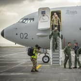 Crew disembark and greet their colleagues with an "elbow bump" at the bottom of the steps of the first of the Poseidon MRA1 planes, intended for submarine-hunting and the tracking of maritime targets, after arriving at RAF Lossiemouth, Moray.