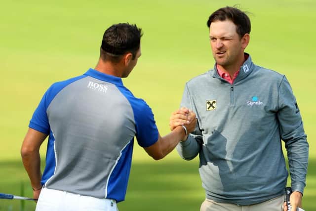 Bernd Wiesberger, right, shakes hands with Martin Kaymer after playing together in the third round at Wentworth. Picture: Andrew Redington/Getty Images.