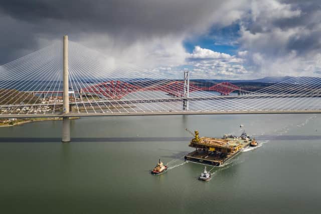 Aerial image of the Iron Lady barge with its cargo of a topside drilling platform for decommissioning being towed by Forth Ports tugs at the Forth Bridges into The Port of Rosyth on Sunday, April 11. Credit: Airbourne Lens