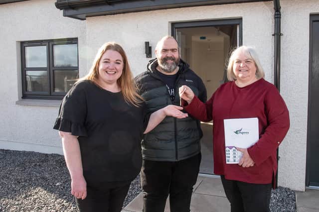 Claire and Adam Mackie receive the keys to their new four-bedroom Johnshaven home from Osprey Housing Officer Elaine Sutherland.