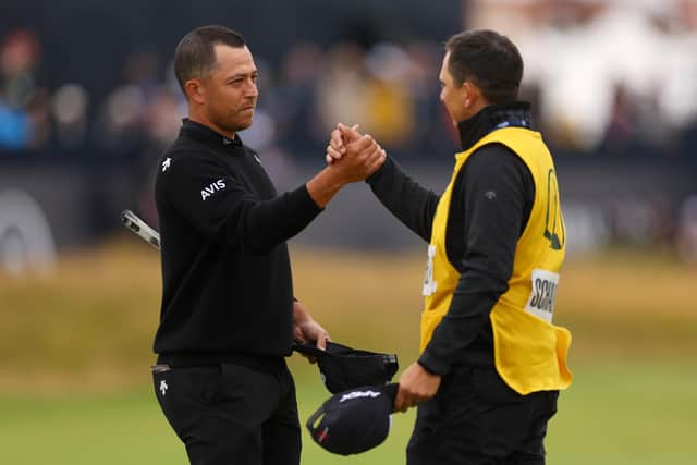 Xander Schauffele celebrates with his caddie Austin Kaiser on the 18th green after winnin the 152nd Open at Royal Troon. Picture: Andrew Redington/Getty Images.