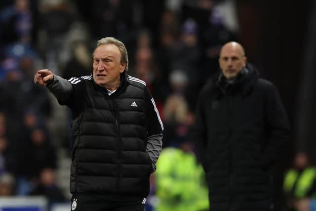 Warnock gives instructions from the sidelines during the Dons' 2-1 defeat.
