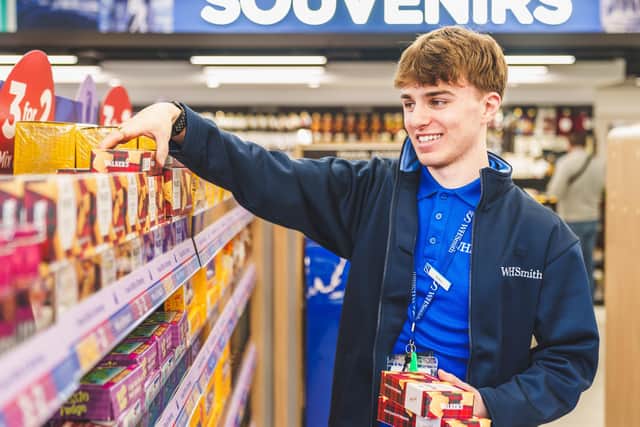A member of the team stocks the shelves in the new airport store. Picture: Jonathan Warner
