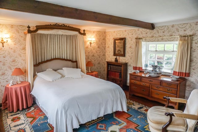 This double bedroom has a lovely beam and looks out onto the garden