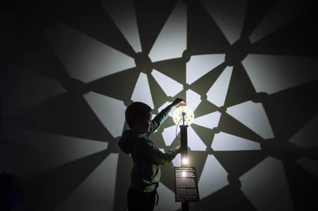 Harry Russell, six, explores the beauty of maths at a special exhibition to celebrate Maths Week Scotland