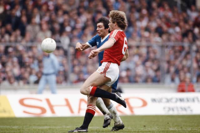 An all Scottish battle as Brighton striker Gordon Smith is challenged by Manchester United defender Gordon McQueen during the 1983 FA Cup final.