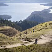 People walking on Conic Hill, above Loch Lomond at Balmaha. Walking up to 10,000 steps per day lowers the risk of heart disease and early death even if people spend most of their day sitting down, research suggests. Picture: Jane Barlow/PA Wire