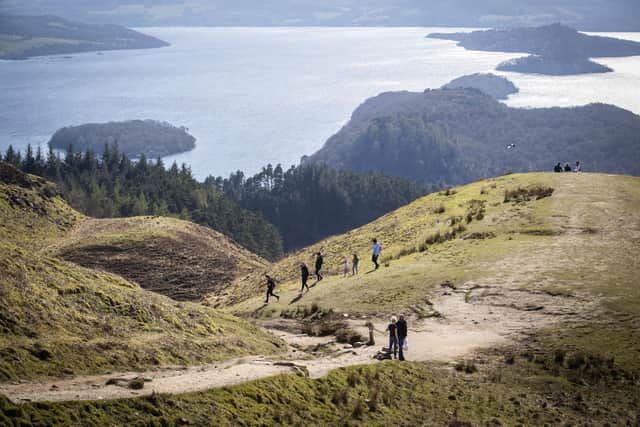 People walking on Conic Hill, above Loch Lomond at Balmaha. Walking up to 10,000 steps per day lowers the risk of heart disease and early death even if people spend most of their day sitting down, research suggests. Picture: Jane Barlow/PA Wire