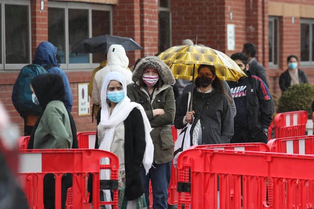 People queuing in the car park for a vaccination at the Glasgow Central Mosque in Glasgow. Glasgow and Moray remain in level three restrictions despite the rest of mainland Scotland moving to level two on Monday. Picture: PA