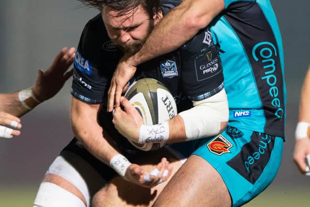 Ryan Wilson in the thick of the action for Glasgow against Dragons' Jamie Roberts. Picture: Bill Murray/SNS