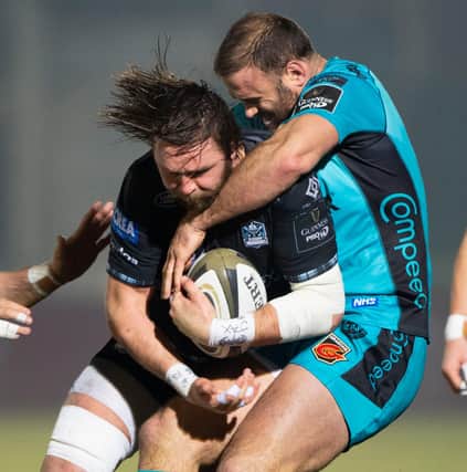 Ryan Wilson in the thick of the action for Glasgow against Dragons' Jamie Roberts. Picture: Bill Murray/SNS