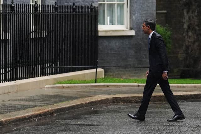 Rishi Sunak walks back into 10 Downing Street after announcing a general election amid a downpour (Picture: Carl Court/Getty Images)