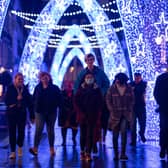 Shoppers walk through Christmas lights on South Molton Street, in central London.