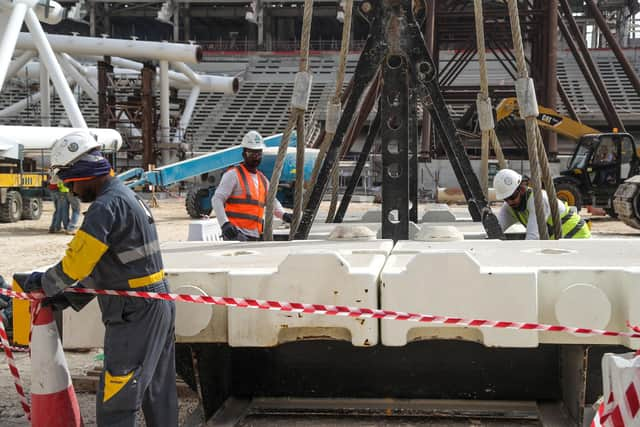 Workers on the construction site at Al-Wakrah Stadium (Al Janoub Stadium), a World Cup venue situated some 15 kilometres on the outskirts of the Qatari capital Doha. (Photo by KARIM JAAFAR/AFP via Getty Images)