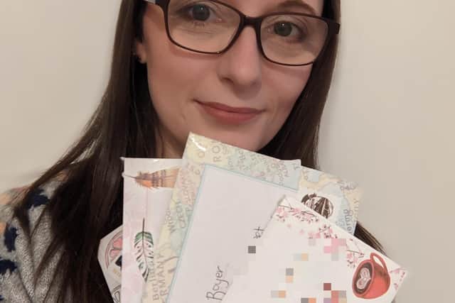 Carly Mendoza with her colourful envelopes ready to send to her newly-formed penpals picture: supplied
