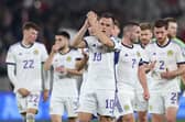 Lawrence Shankland leads his Scotland team-mates in applauding the travelling supporters after the 2-2 draw in Georgia. (Photo by GIORGI ARJEVANIDZE/AFP via Getty Images)