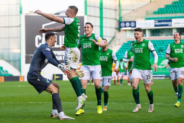 Hibs' goalkeeper Matt Macey prepares to ceebrate with Ryan Porteous after the defender scores the winning penalty in in the shoot out with Motherwell. Photo by Ross Parker / SNS Group