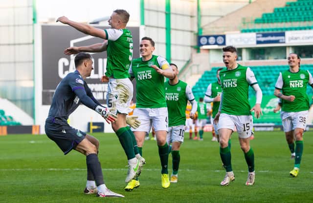 Hibs' goalkeeper Matt Macey prepares to ceebrate with Ryan Porteous after the defender scores the winning penalty in in the shoot out with Motherwell. Photo by Ross Parker / SNS Group