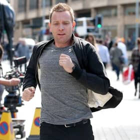 Actor Ewan McGregor on the streets of Edinburgh filming scenes in July 2016 for the sequel Trainspotting T2. He is pictured emulating the famous chase scene through the city centre in the original movie, with the chase starting on Princes Street and ending on Calton Road.