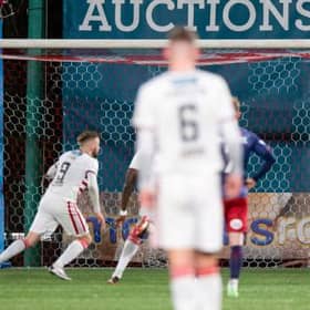 Hamilton's Andy Ryan (L) has his penalty saved by Kilmarnock goalkeeper Zach Hemming during a Cinch Championship match between Hamilton and Kilmarnock at the Fountain of Youth Stadium, on December 26, 2021, in Hamilton, Scotland (Photo by Sammy Turner / SNS Group)