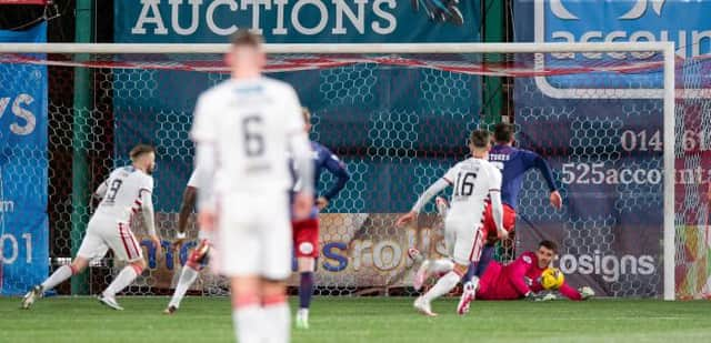 Hamilton's Andy Ryan (L) has his penalty saved by Kilmarnock goalkeeper Zach Hemming during a Cinch Championship match between Hamilton and Kilmarnock at the Fountain of Youth Stadium, on December 26, 2021, in Hamilton, Scotland (Photo by Sammy Turner / SNS Group)